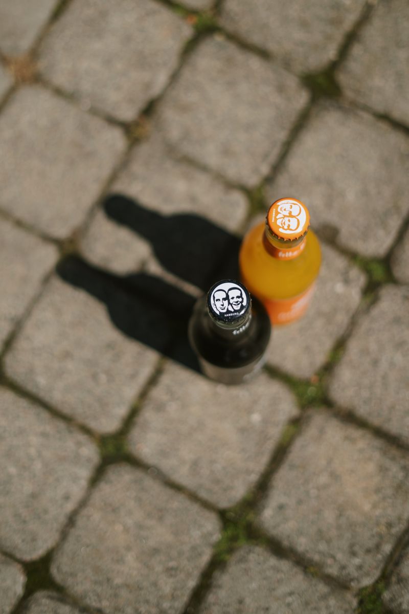 A glass bottle resting on travertine in raking light