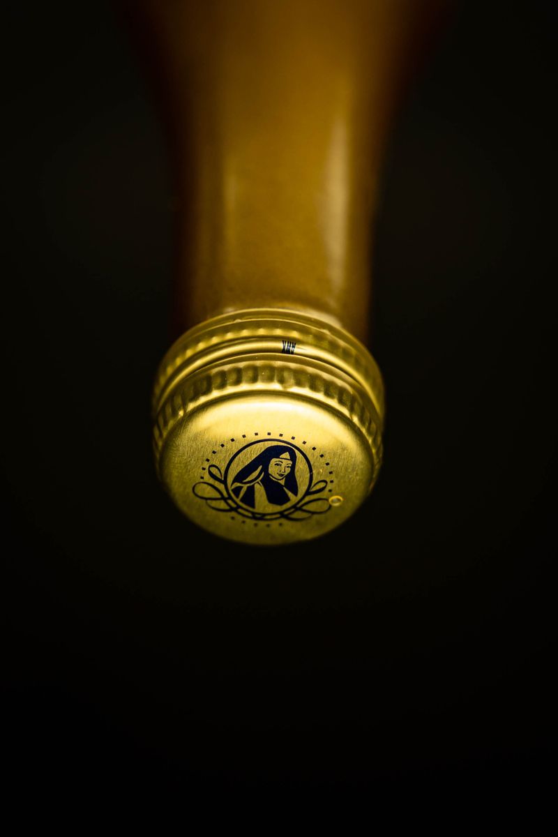 Macro detail of a brushed champagne metal cap